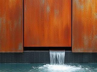 Sleek Corten steel panel with a rustic, protective patina for a modern water feature