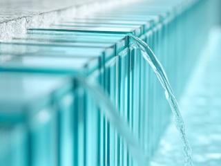 Architectural glass panels interspersed with subtle water flow